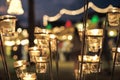 Selective focus on candles in small glasses with blurred bokeh lights in background Royalty Free Stock Photo