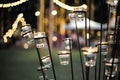 Selective focus on candles in small glasses with blurred bokeh lights in background Royalty Free Stock Photo