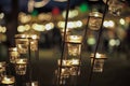 Selective focus on candles in small glasses with blurred bokeh lights in background Royalty Free Stock Photo