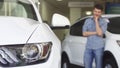 Male customer smiling looking at the new auto at the dealership