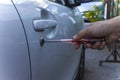 Selective focus on car key remote and tools in man`s hand open the car door. life concept.Close-up Royalty Free Stock Photo