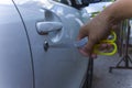 Selective focus on car key remote and tools in man`s hand open the car door. life concept.Close-up Royalty Free Stock Photo