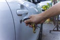 Selective focus on car key remote and tools in man`s hand open the car door. life concept.Close-up Royalty Free Stock Photo