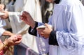 Selective focus, catholic priests distributing the communion wafer Royalty Free Stock Photo