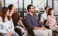 Selective focus on caucasian beard working man wearing eyeglasses, business shirt, doing workshop in indoor seminar room and