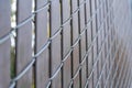 Selective focus of a chain link fence with brown privacy strips at Japanese Friendship Garden Royalty Free Stock Photo