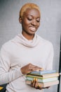 Selective focus of cheerful african american woman holding books Royalty Free Stock Photo