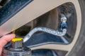 Selective focus on chemical additive sprayed from a can into a tire to fix a flat Royalty Free Stock Photo