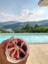 Selective focus on cherries ice cream in front of the swimming p Royalty Free Stock Photo