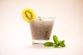 Selective focus of chia seeds drink with water in transparent glass with lemon balm.