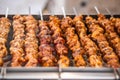 Chicken kebabs cooking on a charcoal grill