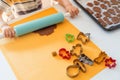 Selective focus. Child helping to making gingerbread cookies with various Christmas cookie cutters. Gingerbread dough. Family Royalty Free Stock Photo