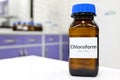 Selective focus of chloroform or trichloromethane liquid chemical in glass amber bottle inside a chemistry laboratory. Royalty Free Stock Photo