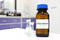 Selective focus of chloroform or trichloromethane liquid chemical in glass amber bottle inside a chemistry laboratory. Royalty Free Stock Photo