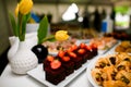 selective focus of chocolate brownie with strawberries on the table with desserts.