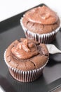 Selective focus on chocolate cup cake muffin on the black square plate Royalty Free Stock Photo