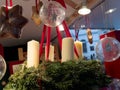 Selective focus of christmas advent wreath with candles on counter with different decor