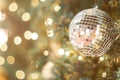Selective focus Christmas tree with holiday silver disco balls and lights with copy space on blurred bokeh background Royalty Free Stock Photo