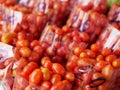 Selective focus of clean fresh small red tomatoes in a plactic bags for sale at a local market Royalty Free Stock Photo