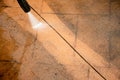 Selective focus. Cleaning backyard paving tiles with high pressure washer