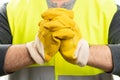 Selective focus close-up of builder with yellow work gloves Royalty Free Stock Photo