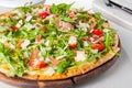Selective focus Close up Delicious Pizza with hamon and cherry tomato slices, parmezan cheese and arugula on the wooden board Royalty Free Stock Photo