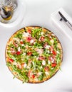 Selective focus Close up Delicious Pizza with hamon and cherry tomato slices, parmezan cheese and arugula on the wooden board on Royalty Free Stock Photo