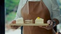 Waitress serve bakery to young muslim woman in coffee shop Royalty Free Stock Photo