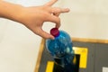 Selective focus close up hand throwing an empty plastic bottle in the recycling garbage trash or bin Royalty Free Stock Photo