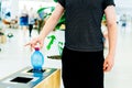 Selective focus close up hand throwing an empty plastic bottle in the recycling garbage trash or bin Royalty Free Stock Photo