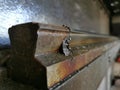 Close up image of metal sheet bending machine railing with blurry background. Royalty Free Stock Photo