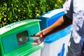 black hand throwing an empty plastic water bottle in the recycling garbage trash Royalty Free Stock Photo