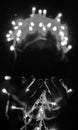 Selective focus. Close-up photo of woman\'s hands with fairy garlands lights. Merry Christmas and Happy new year. Royalty Free Stock Photo