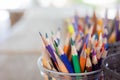 Selective focus and close up shot with copy space of many multi-colored pencils standing in the case in bright sunlight shows Royalty Free Stock Photo