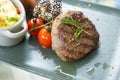 Selective focus and close up shot of well prepared beef juicy steak with luxury decoration of mash potato, sauce and tomatoes Royalty Free Stock Photo