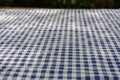 Selective focus and close up shot of white-blue checker pattern fabric on table shows beautiful detail woven textile. It is retro