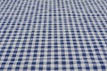 Selective focus and close up shot of white-blue checker pattern fabric on table shows beautiful detail woven textile. It is retro