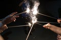 In selective focus on close-up sparklers fireworks in hands.Happy friends having fun with sparkler Royalty Free Stock Photo