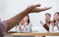 Selective focus and close up to man& x27;s hand presented in meeting room at indoor office or seminar with blur background of