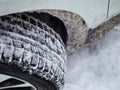 Selective focus. Close-up of a winter car tire tread with snow and ice Royalty Free Stock Photo