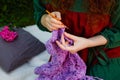 Selective focus. Close-up of women`s hands knitting a shawl