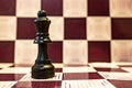 Selective focus closeup of a black queen chess piece on a chessboard Royalty Free Stock Photo