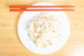 Selective focus closeup of a chopstick on the Chinese fried rice