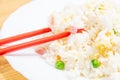 Selective focus closeup of a chopstick on the Chinese fried rice