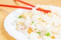 Selective focus closeup of a chopstick on the Chinese fried rice