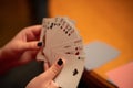 Selective focus closeup of a hand holding a hand of playing cards Royalty Free Stock Photo