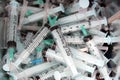 a closeup of medical waste of sharp needles, syringes inside a safety box, dangerous sharp used objects Royalty Free Stock Photo