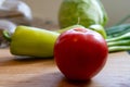 Selective focus closeup of ripe tomato with few more vegetables in the background Royalty Free Stock Photo