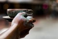 Selective focus closeup shot of the hand of a bronze statue holding a cup