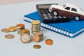 Selective focus of coins and blue toy car on white Royalty Free Stock Photo